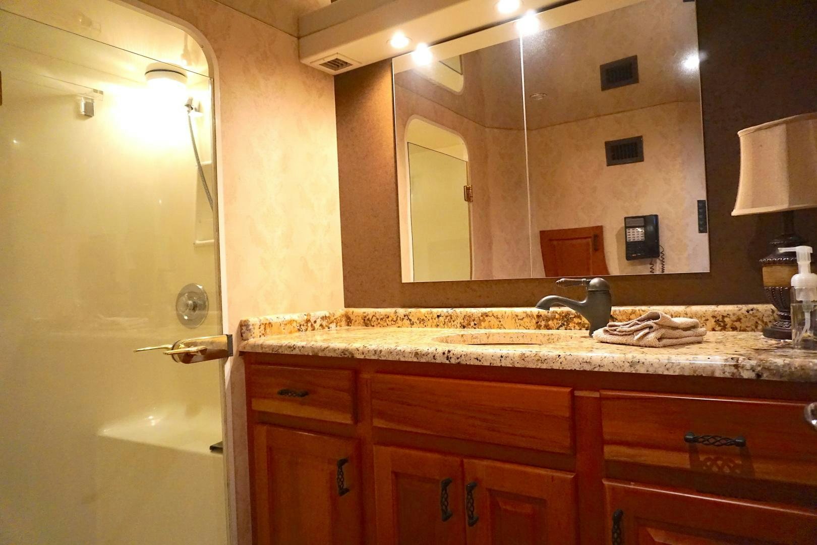 a bathroom with a large mirror aboard CROWN ROYAL Yacht for Sale