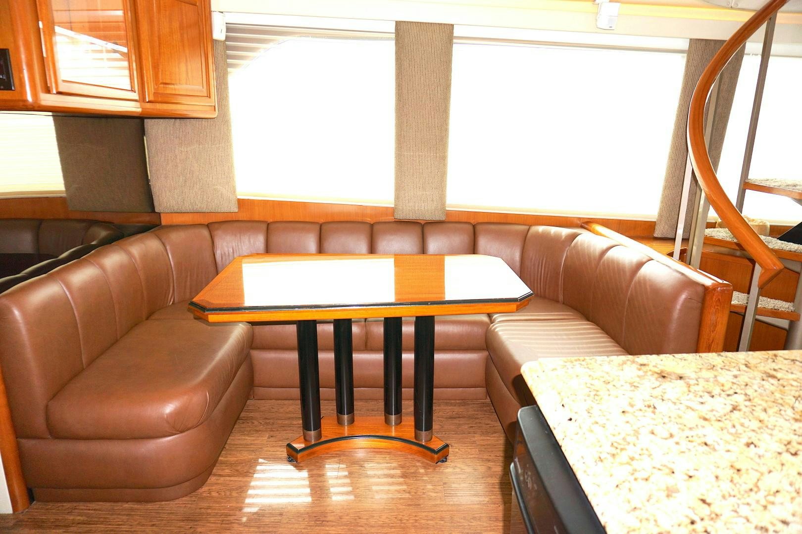 a living room with a couch and a table aboard CROWN ROYAL Yacht for Sale