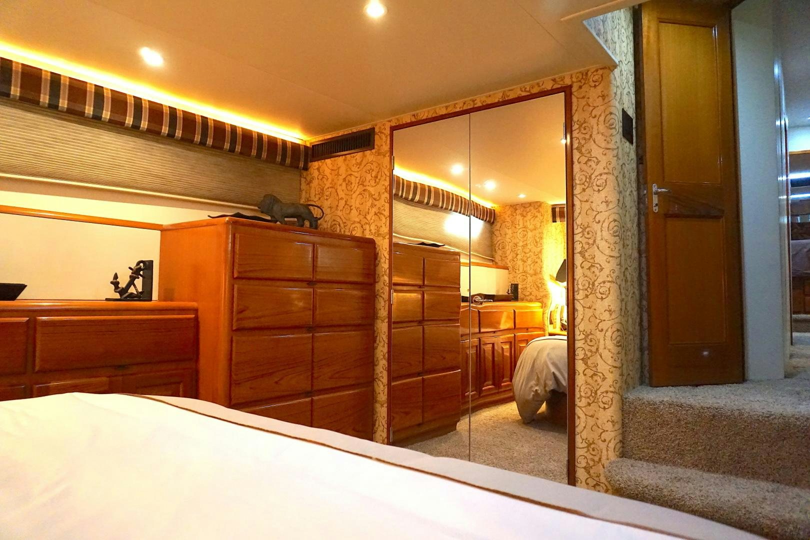 a bedroom with a wood wall aboard CROWN ROYAL Yacht for Sale