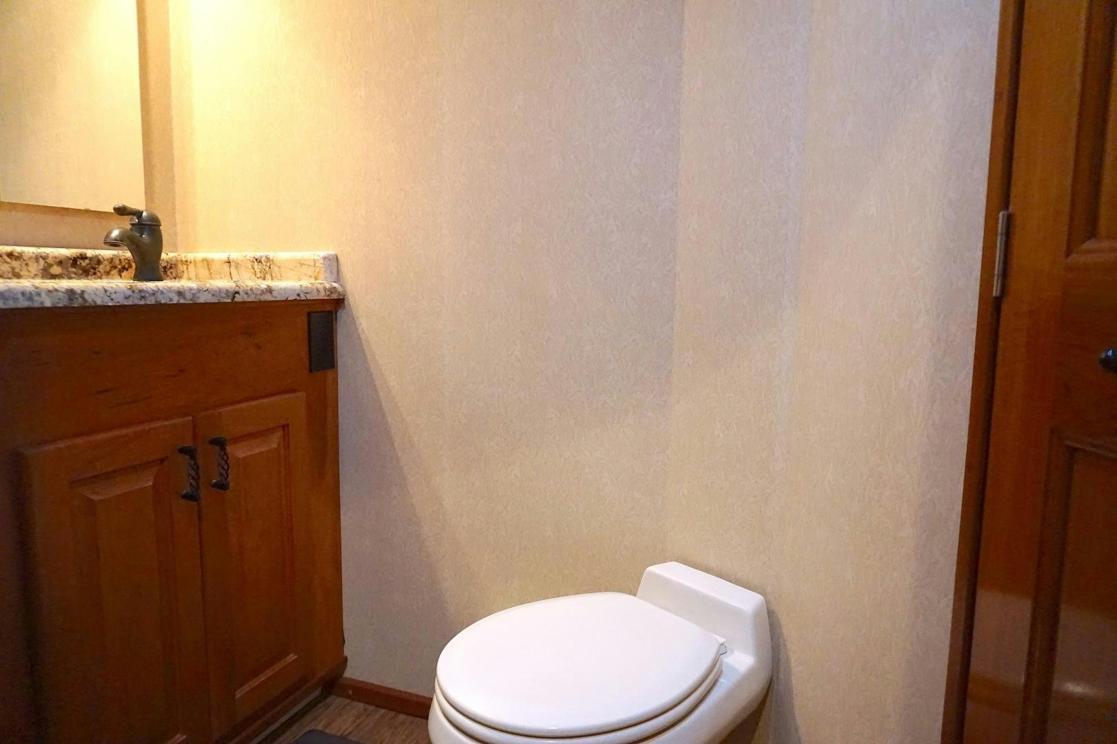 a bathroom with a toilet and sink aboard CROWN ROYAL Yacht for Sale