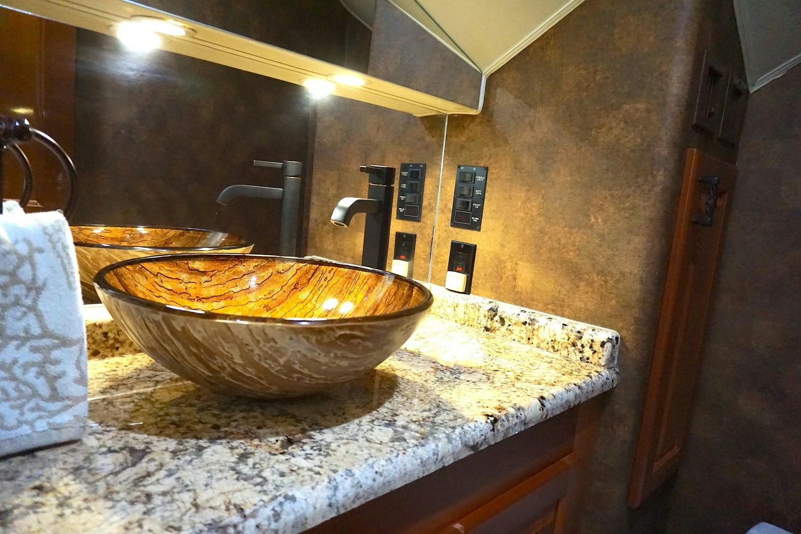 a bathroom with a marble counter top aboard CROWN ROYAL Yacht for Sale