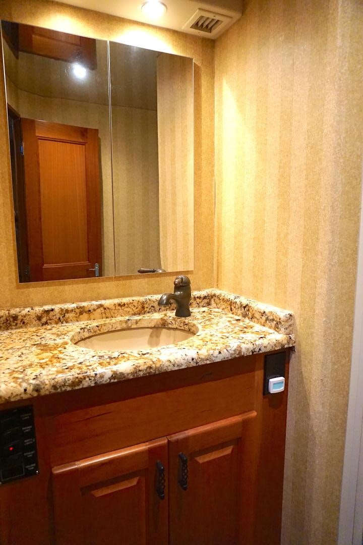 a bathroom with a sink and a mirror aboard CROWN ROYAL Yacht for Sale