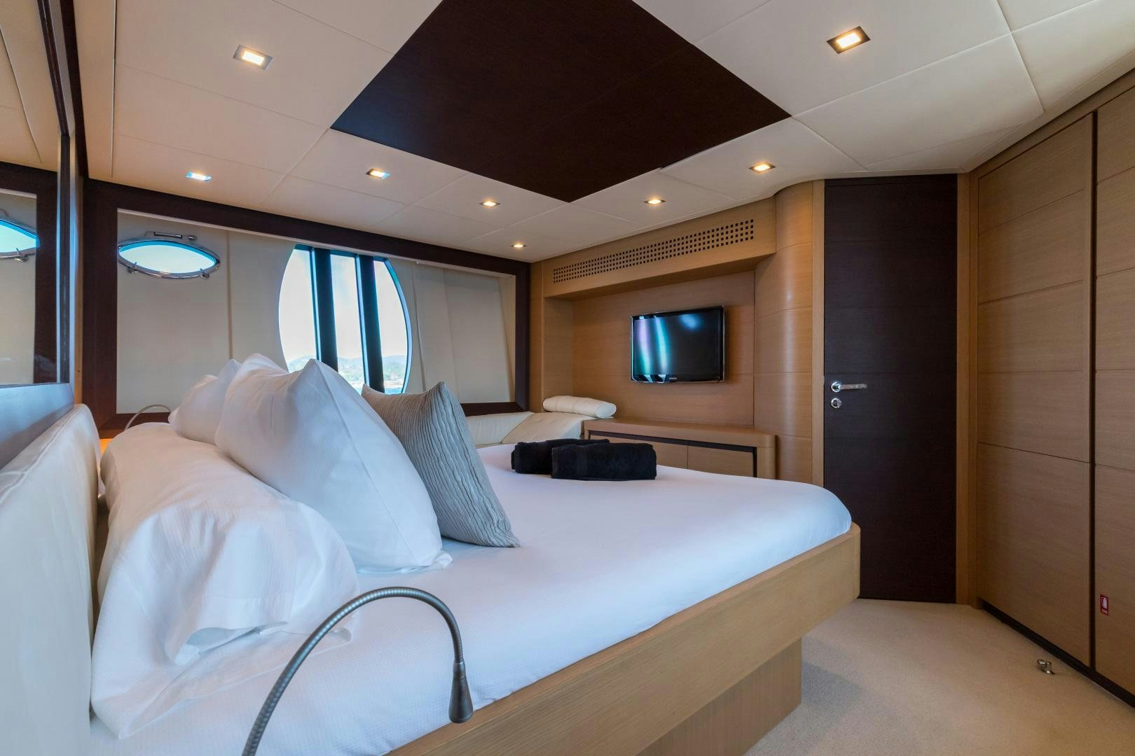 a room with a bed and a television aboard LOONEY Yacht for Sale