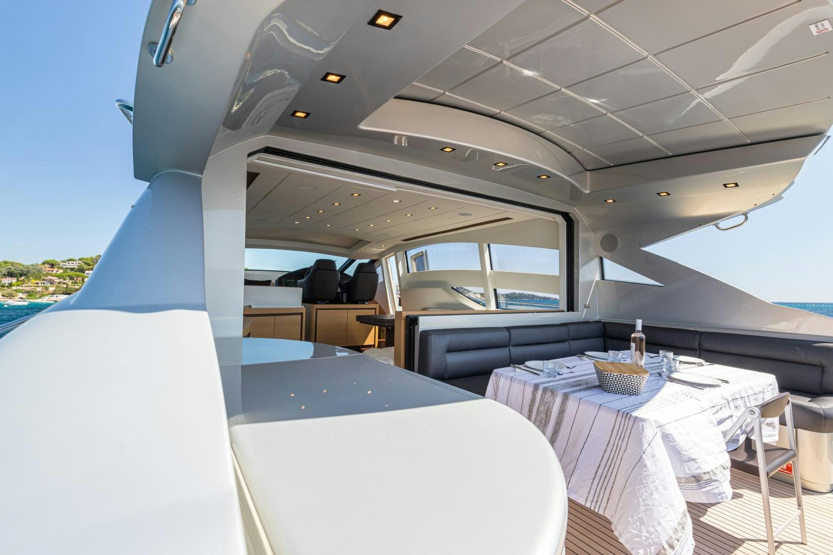 a boat with a table and chairs aboard LOONEY Yacht for Sale