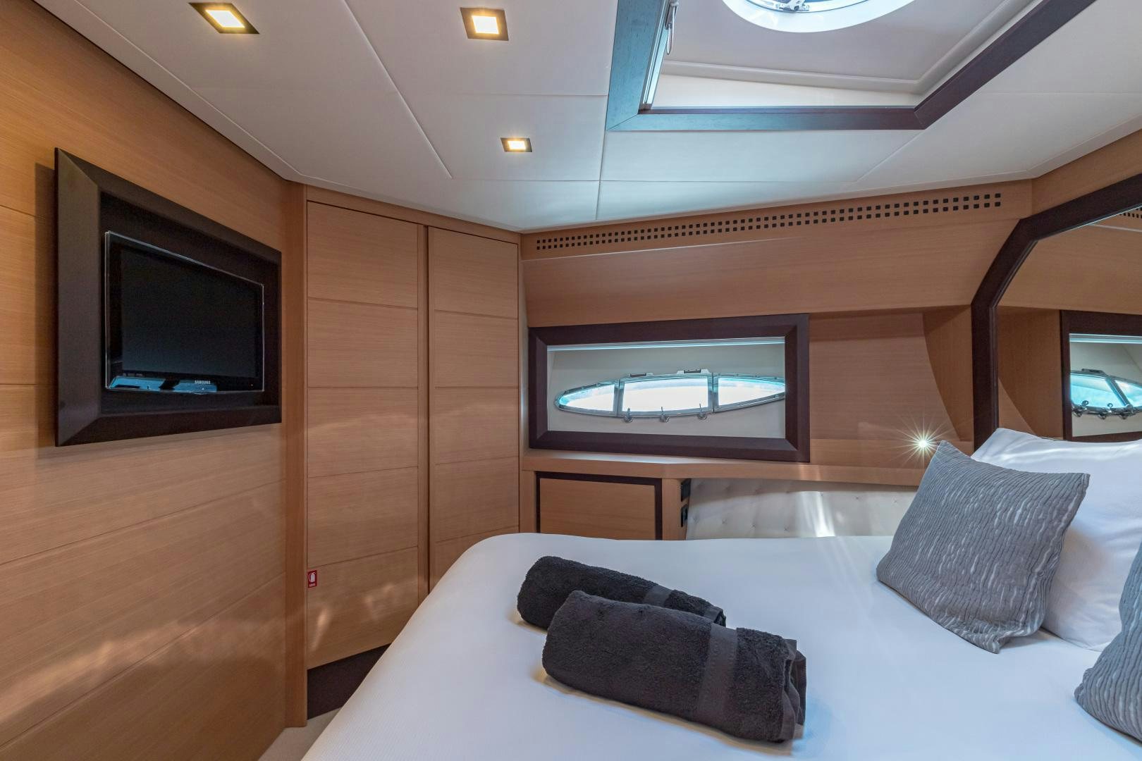 a room with a bed and a television aboard LOONEY Yacht for Sale