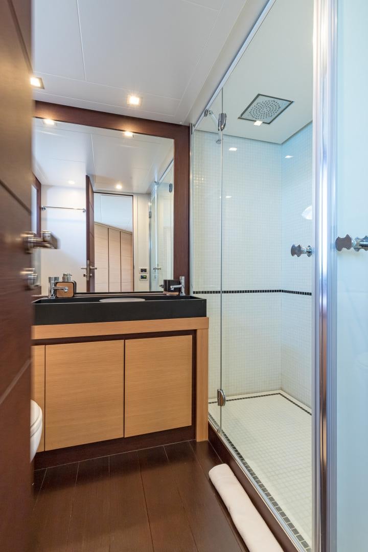 a bathroom with a glass shower aboard LOONEY Yacht for Sale