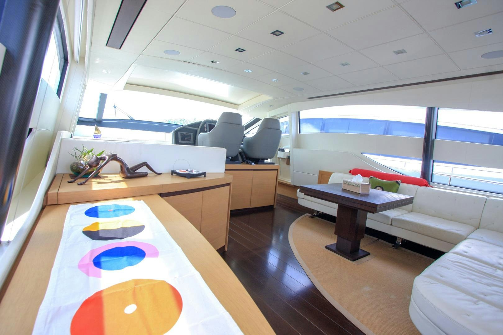 a room with a table and chairs aboard TOYZ4BOYZ Yacht for Sale
