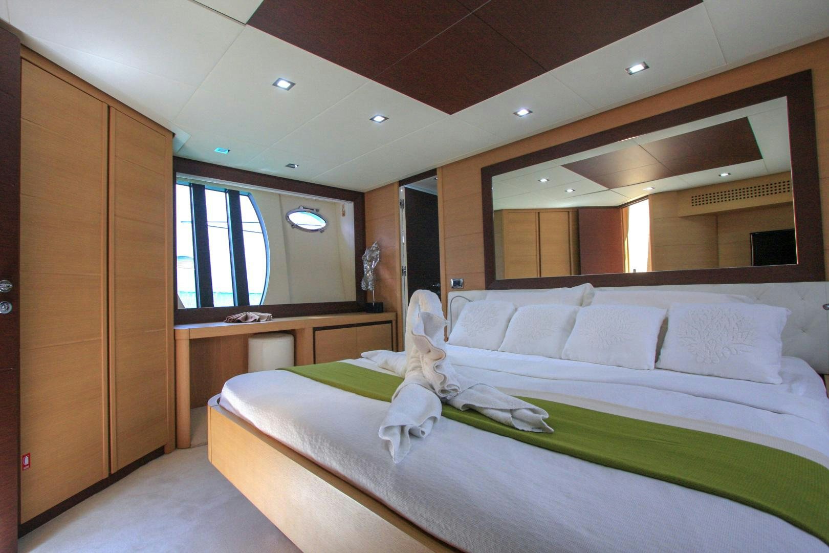 a room with a bed and a desk aboard TOYZ4BOYZ Yacht for Sale