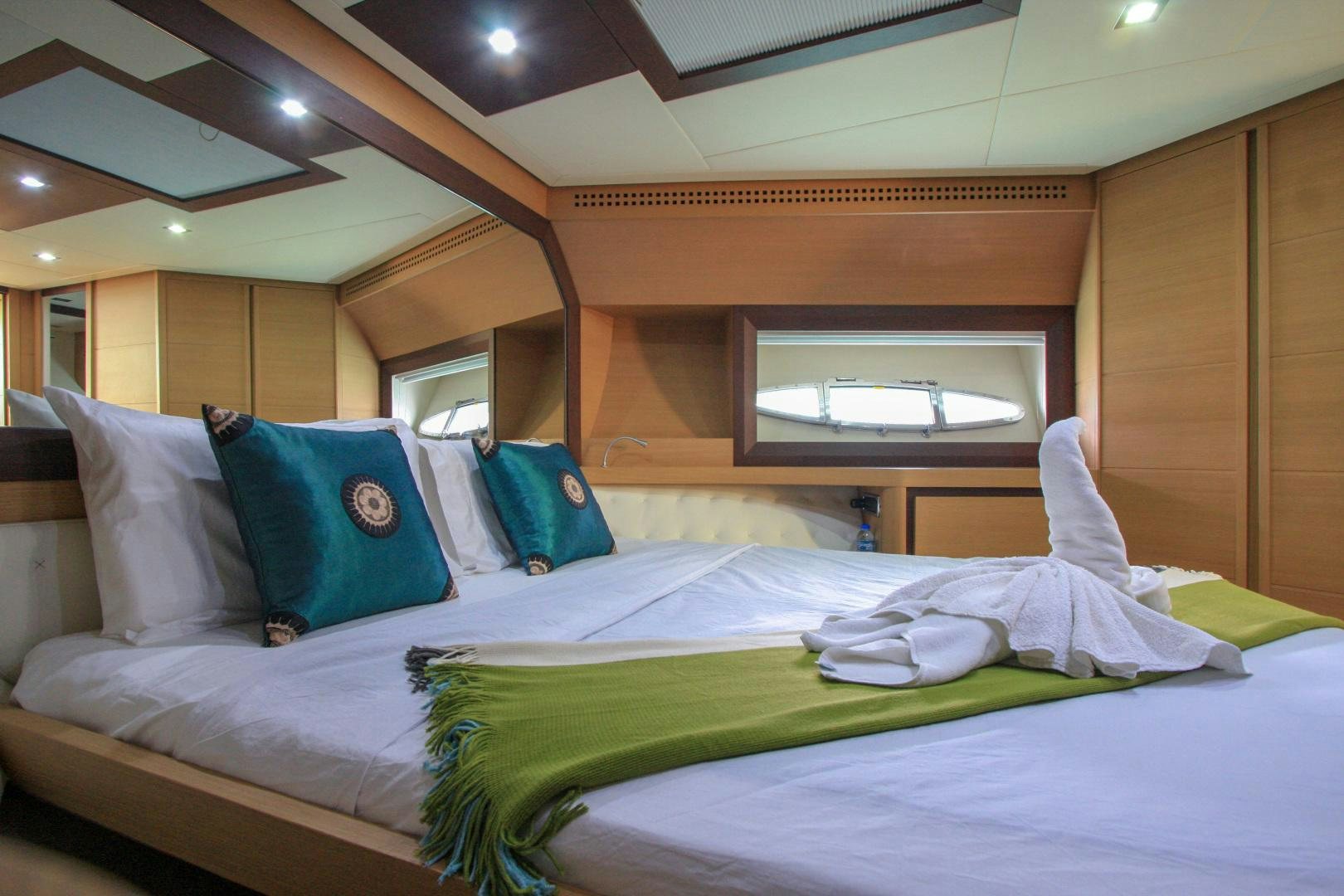 a bed with pillows aboard TOYZ4BOYZ Yacht for Sale