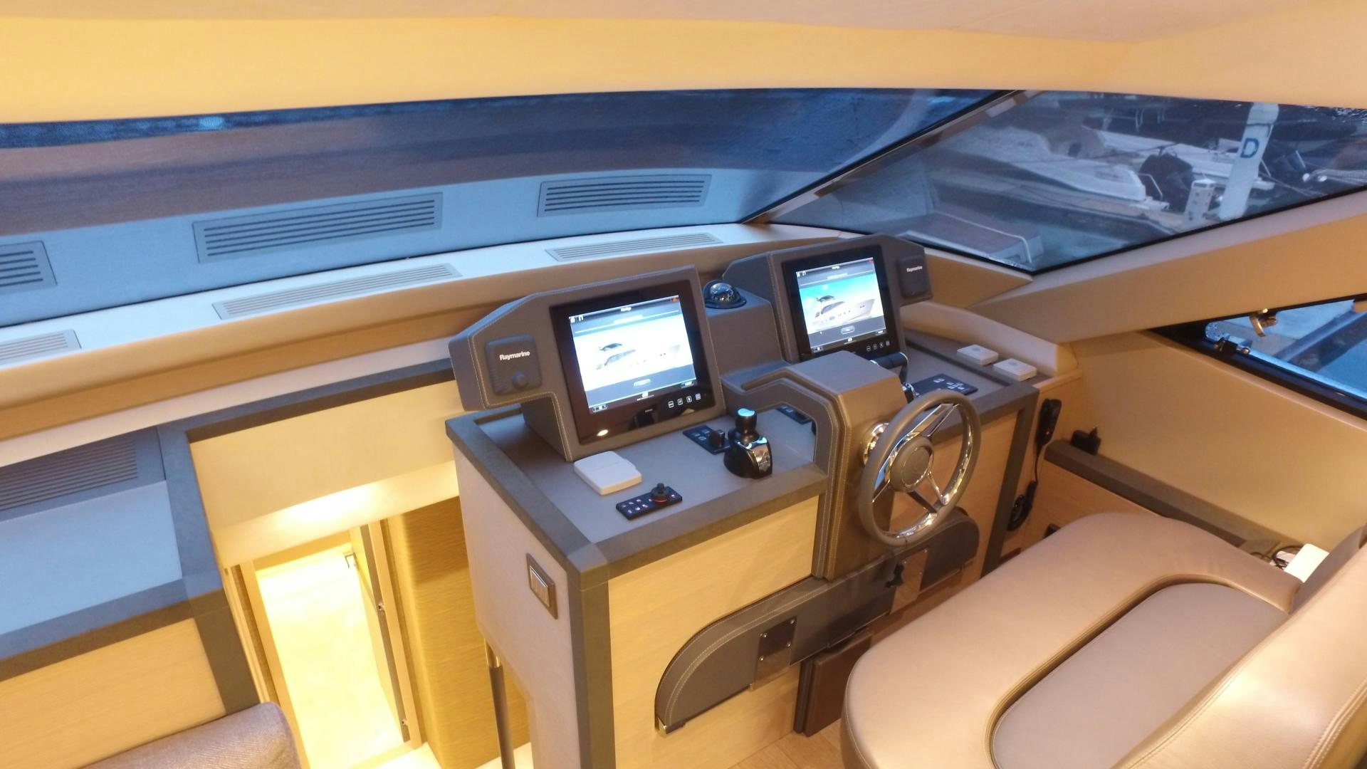 a vehicle with a screen and a desk with computers on it aboard WASANA Yacht for Sale