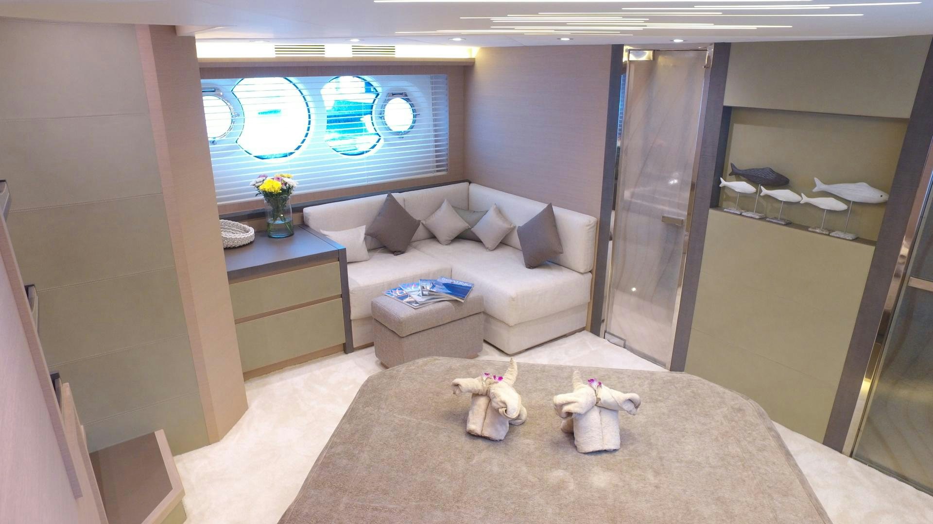 a room with a couch and a table with a couple of cups on it aboard WASANA Yacht for Sale