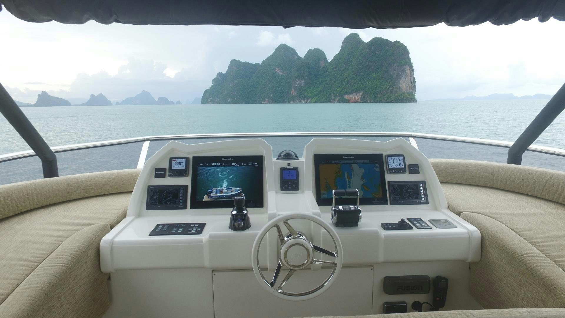a white car on a road aboard WASANA Yacht for Sale