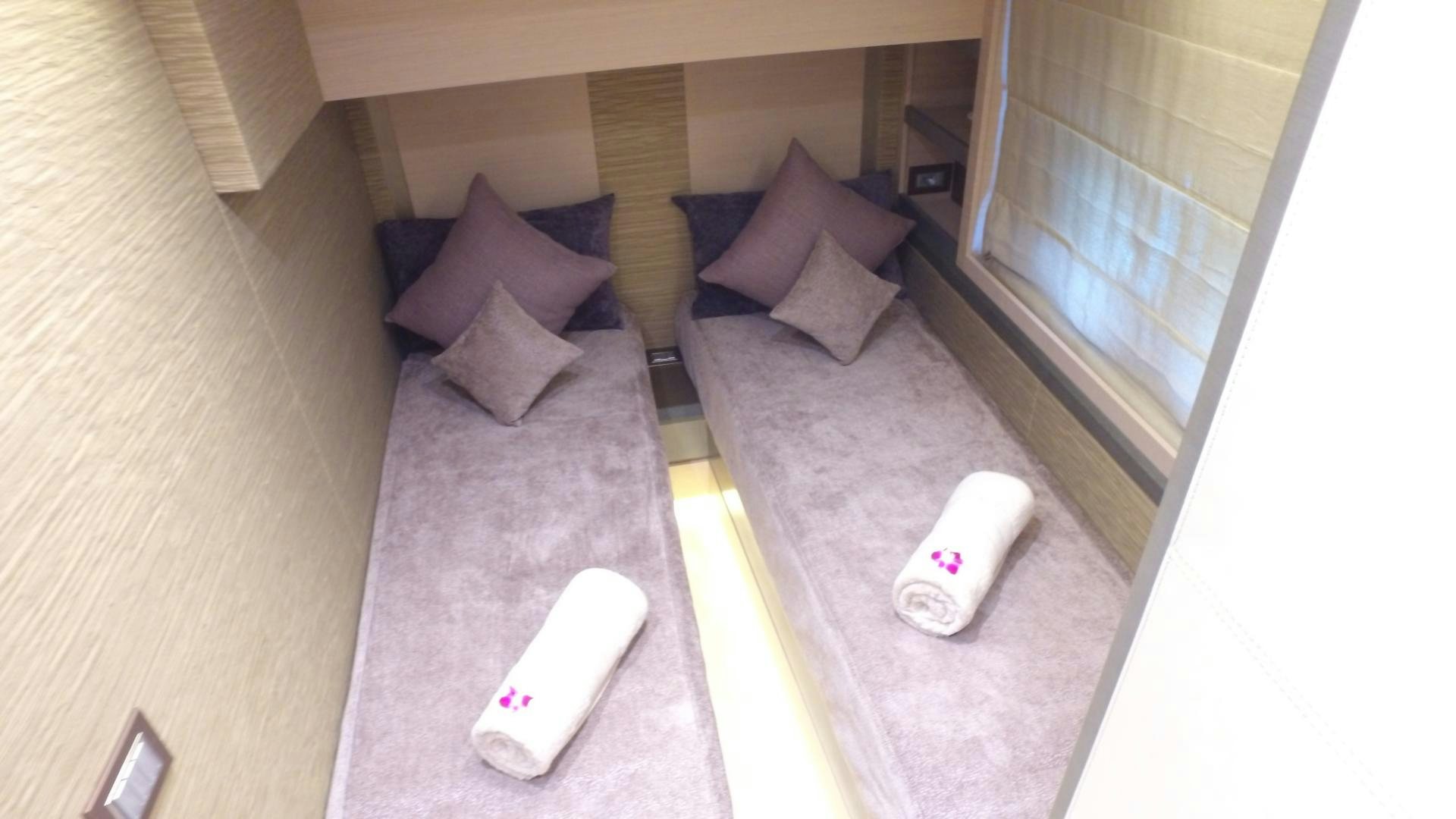 a bed with a bed and a pillow on it aboard WASANA Yacht for Sale