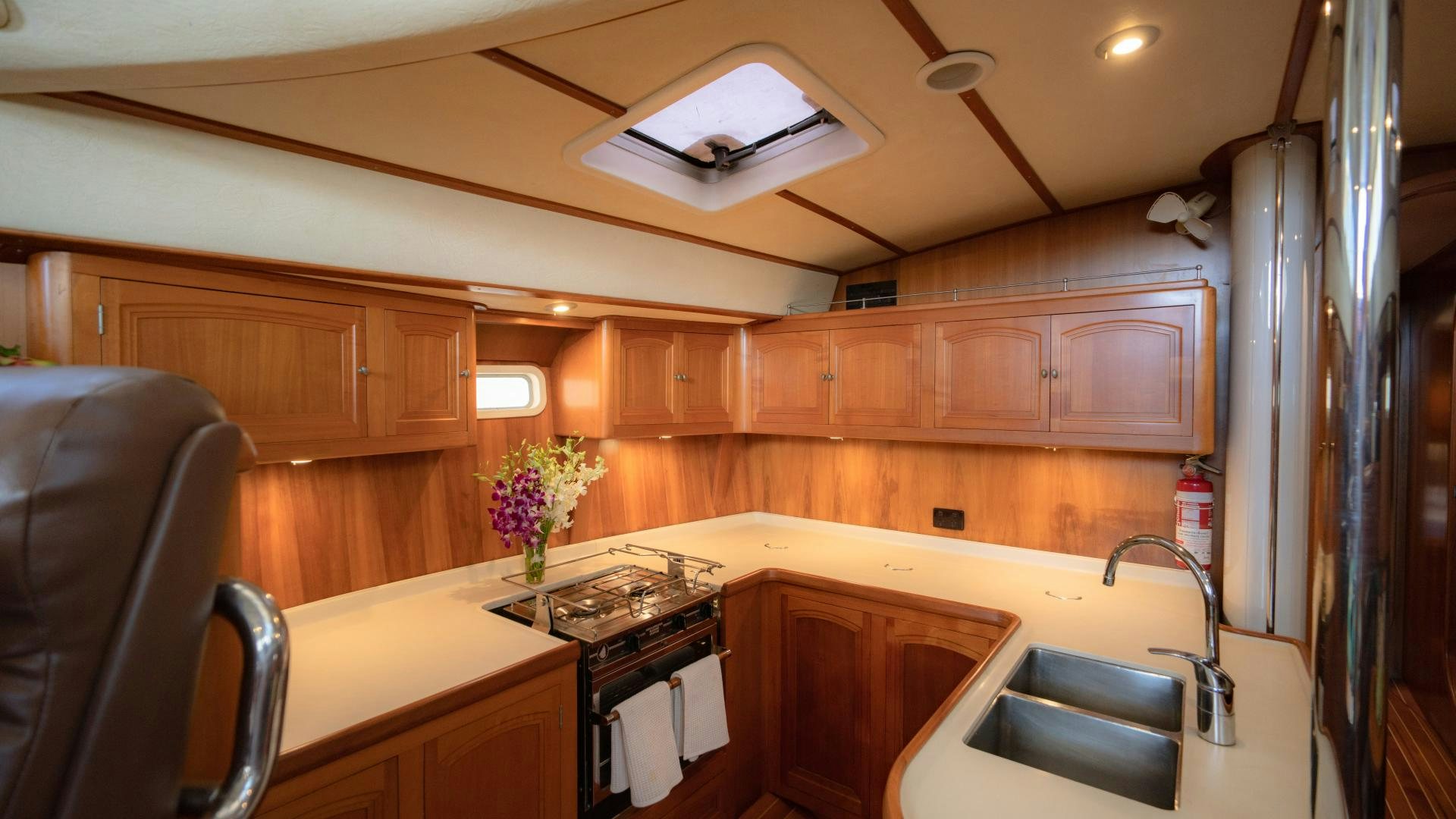 a kitchen with wooden cabinets aboard MI LIAN  Yacht for Sale