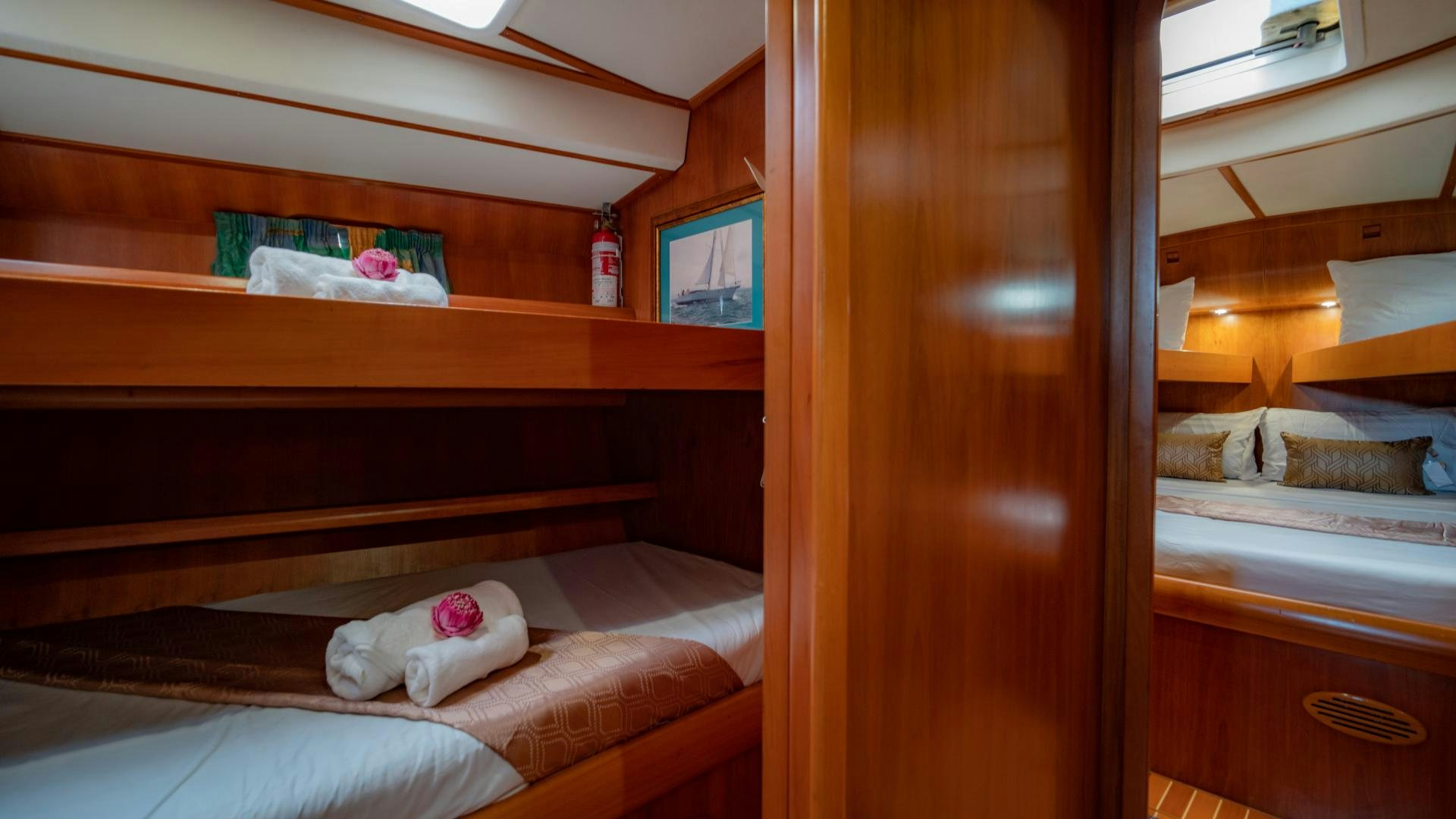 a room with a bed and a shelf with a mirror aboard MI LIAN  Yacht for Sale
