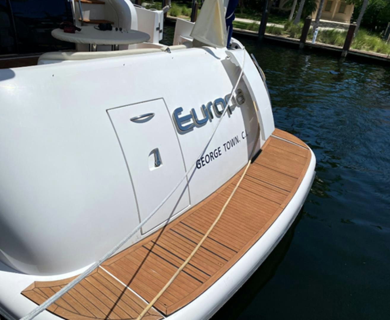 a white boat on a dock aboard EUROPA Yacht for Sale