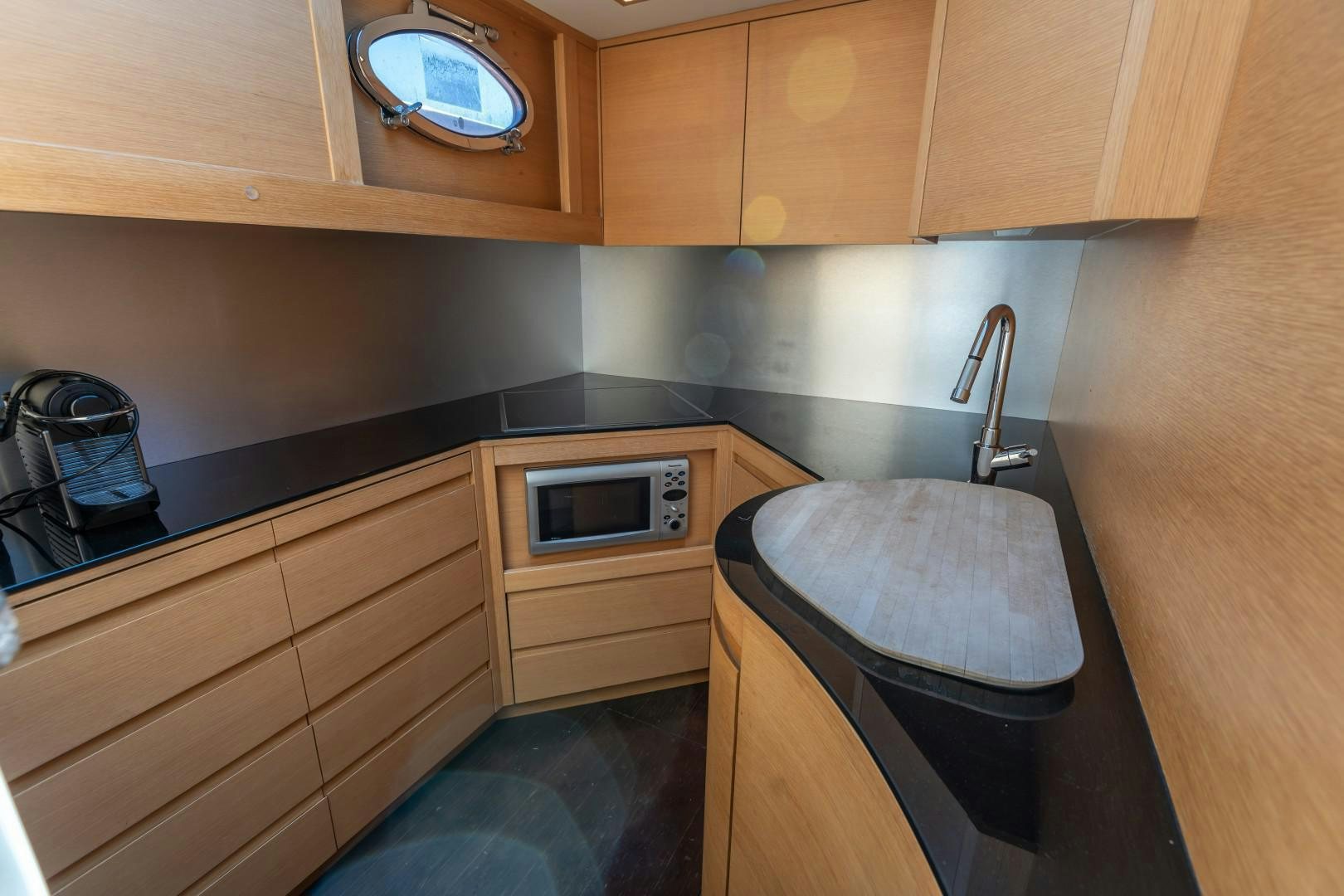 a kitchen with wooden cabinets aboard FIRST LADY Yacht for Sale