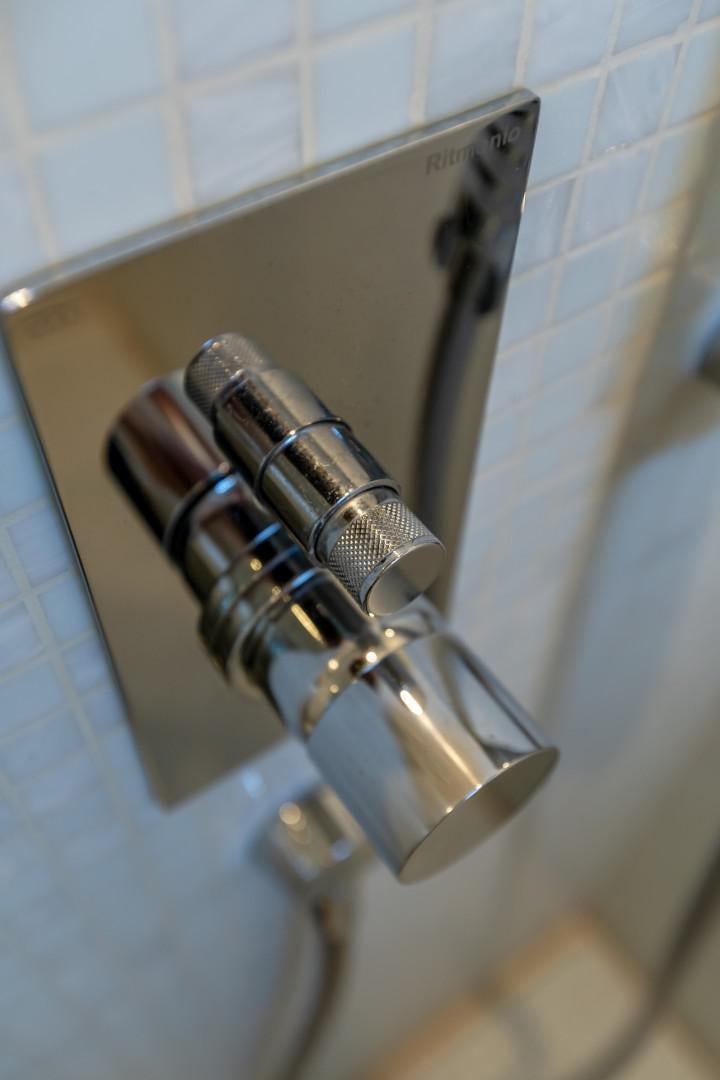 a metal faucet on a tile wall aboard FIRST LADY Yacht for Sale