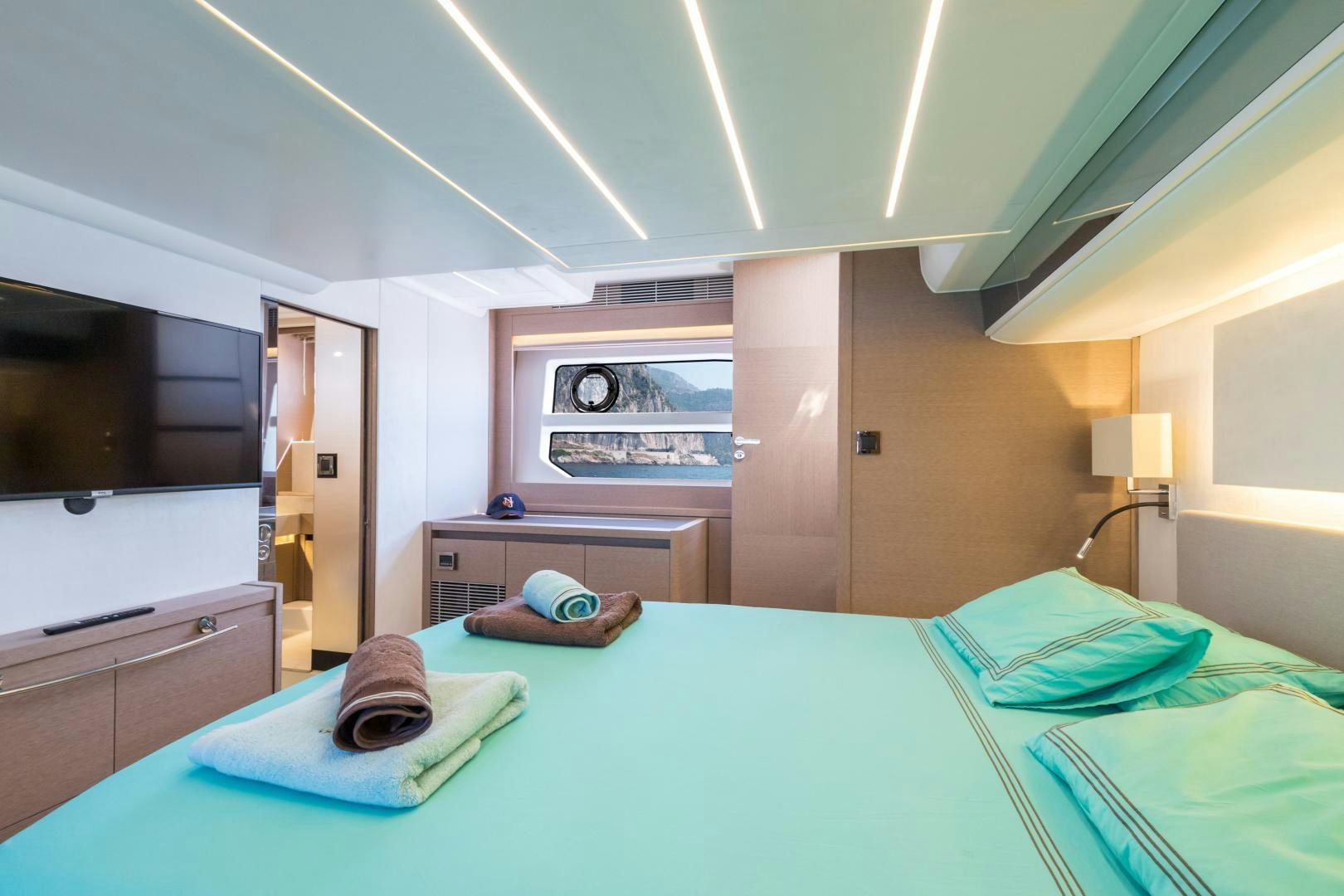 a large bedroom with a large bed aboard LA HUNE 4.0 Yacht for Sale