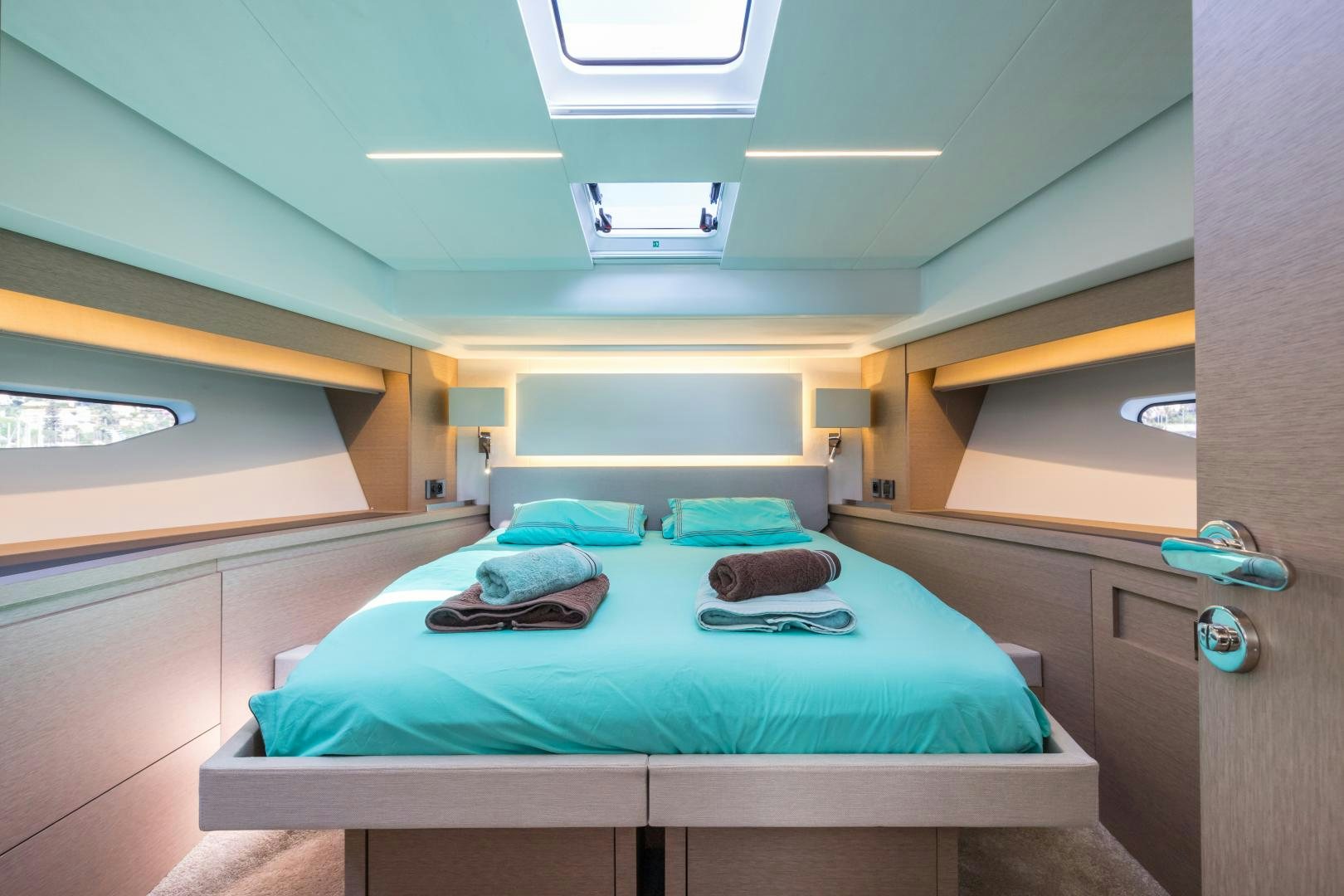 a room with a bed and a window aboard LA HUNE 4.0 Yacht for Sale