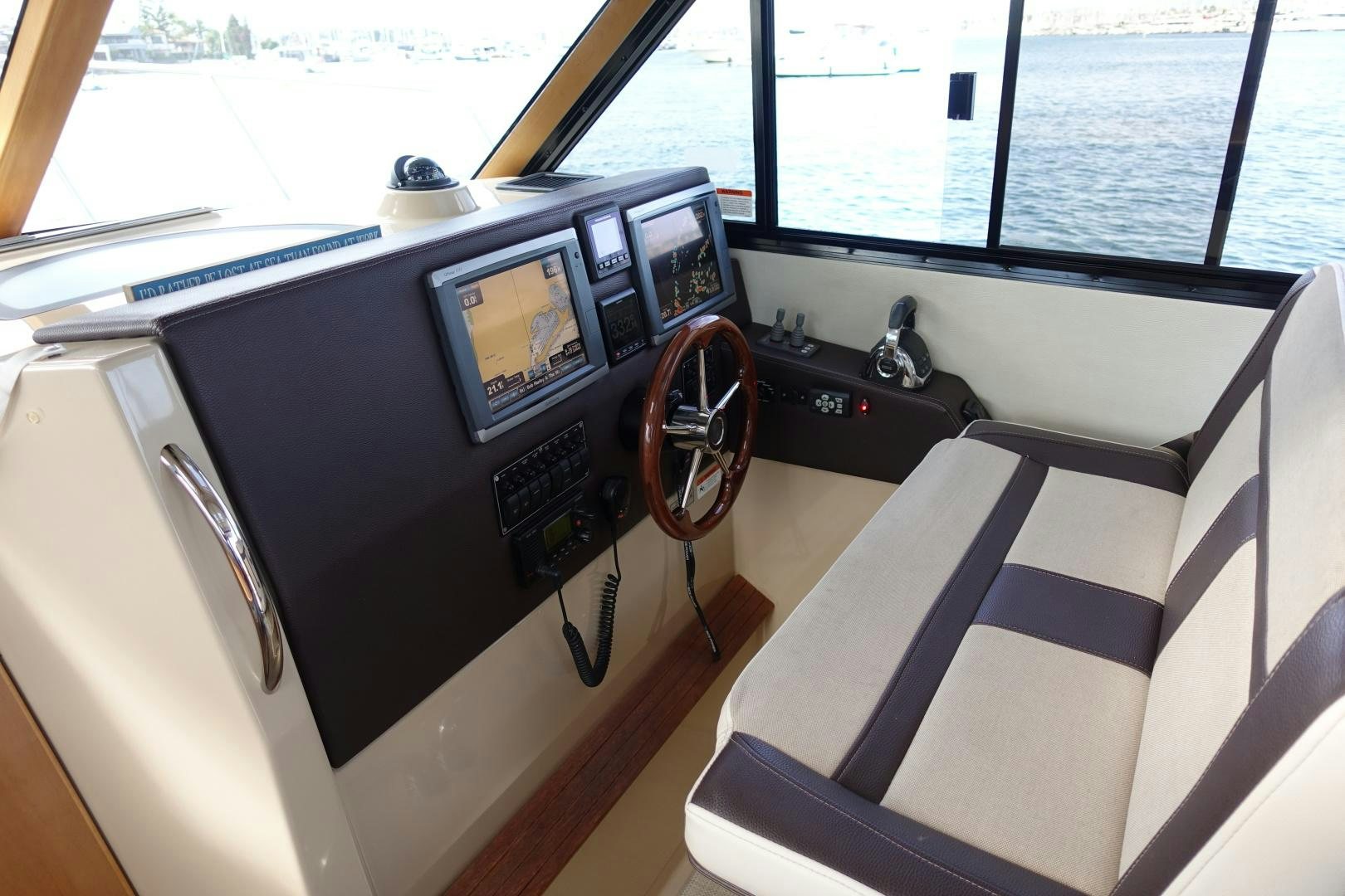 a boat with a steering wheel and a seat aboard OHANA Yacht for Sale