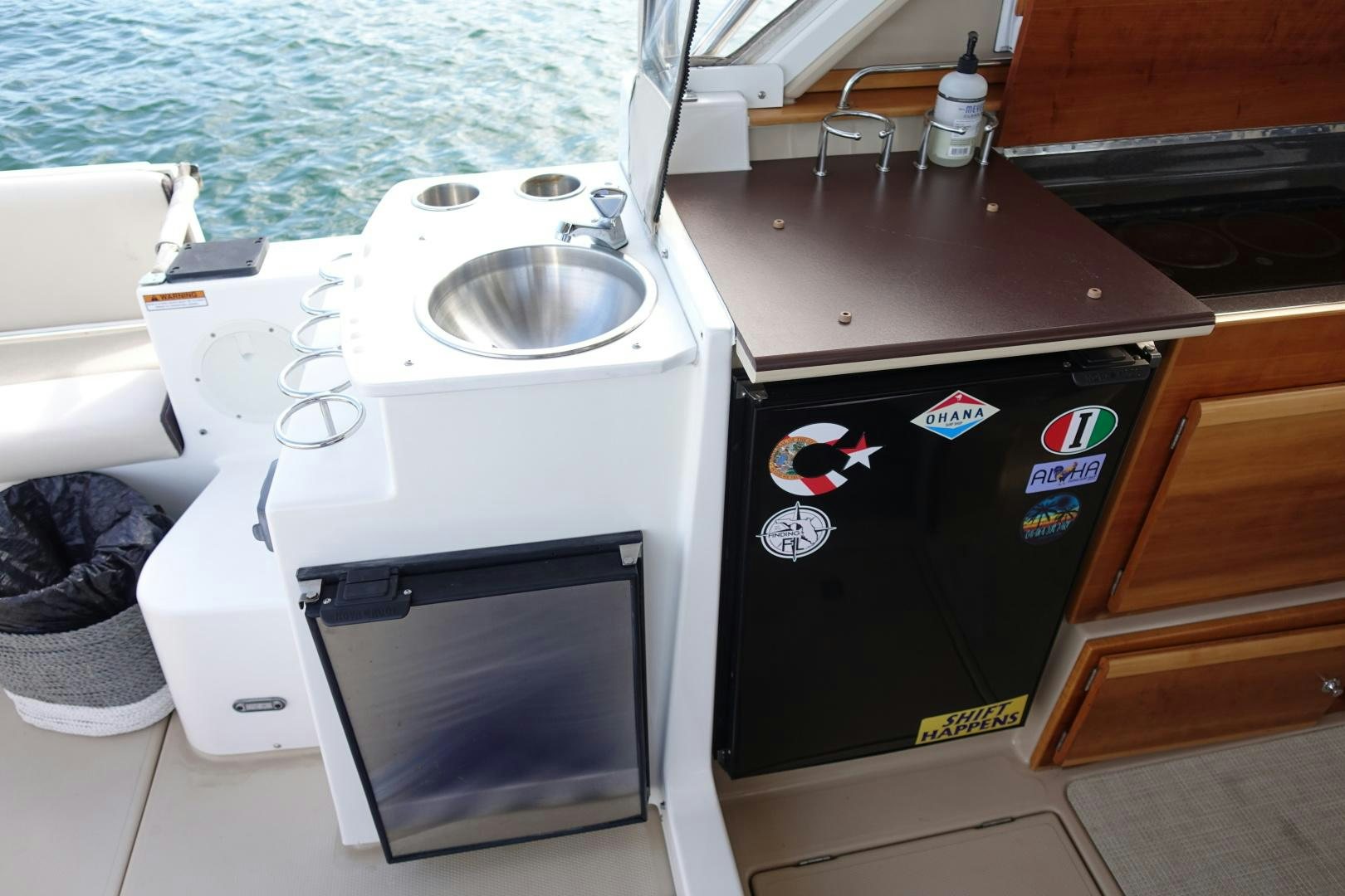 a white stove next to a sink aboard OHANA Yacht for Sale
