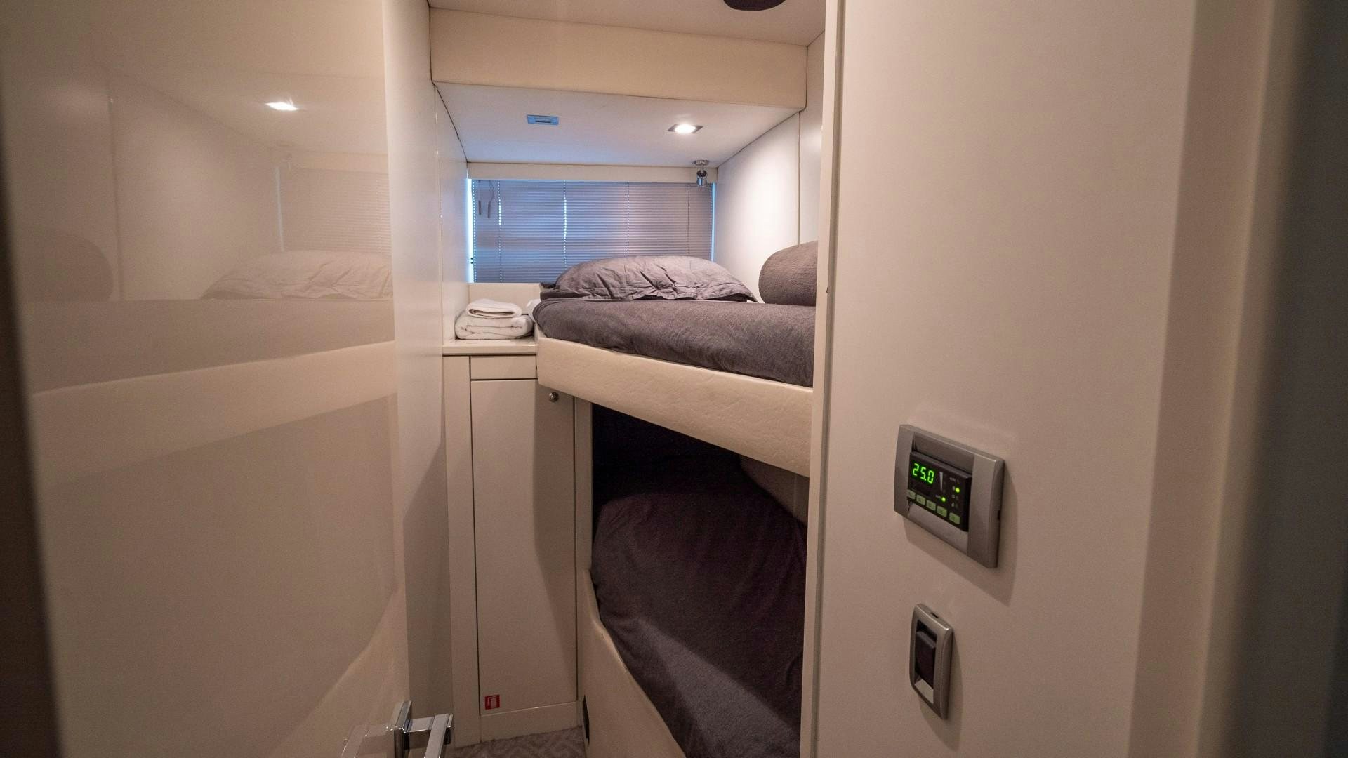 a room with a bed and a desk aboard SPLASHED OUT Yacht for Sale