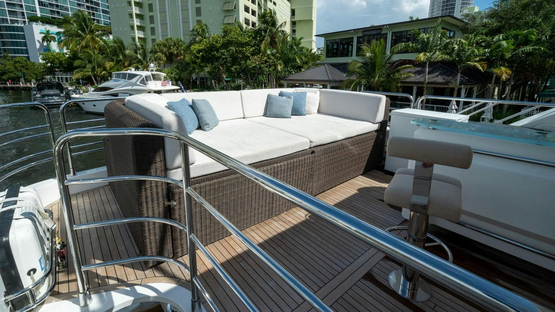 a deck with a couch and chairs aboard SPLASHED OUT Yacht for Sale