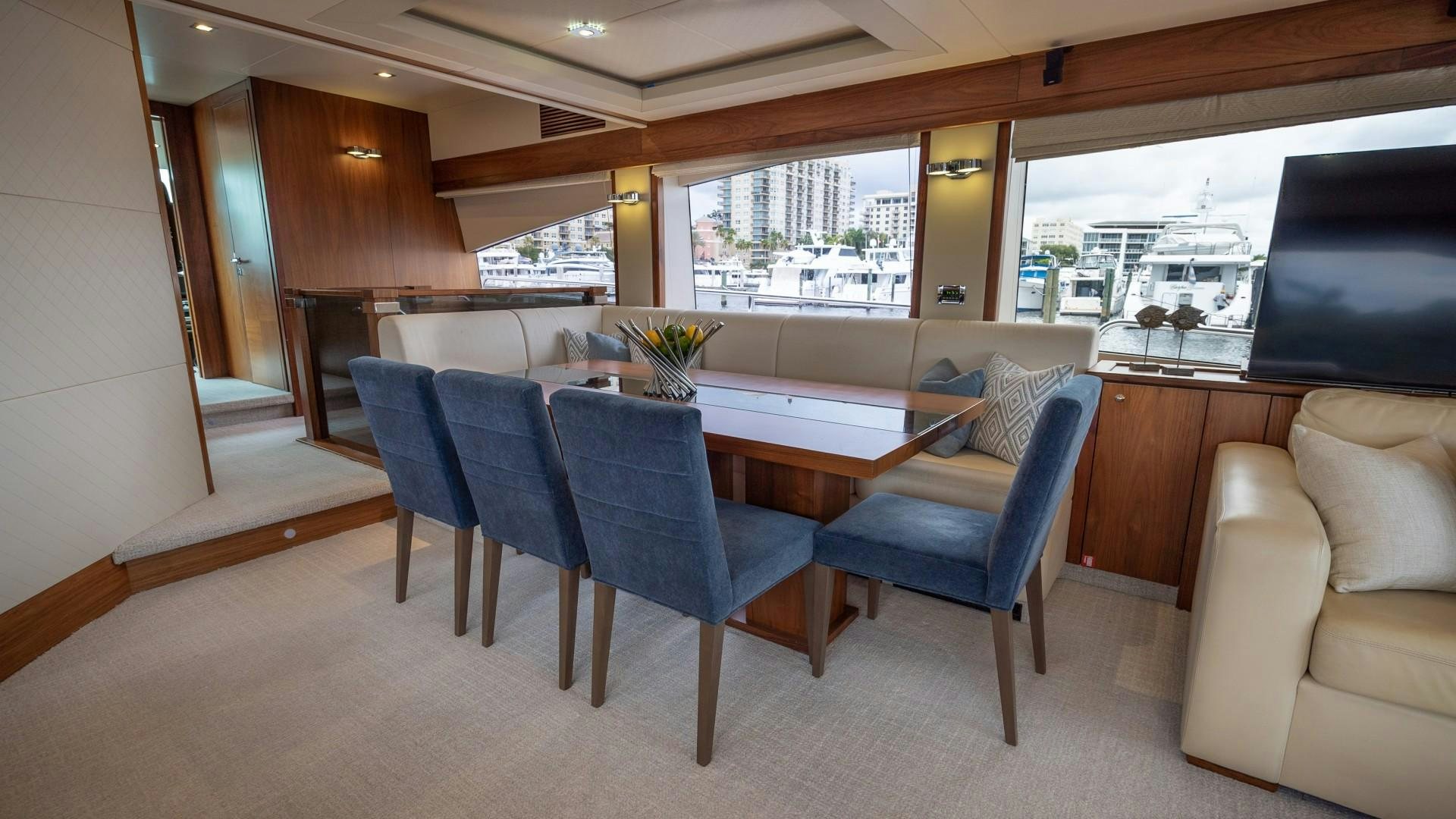 a dining room with a table and chairs aboard SPLASHED OUT Yacht for Sale