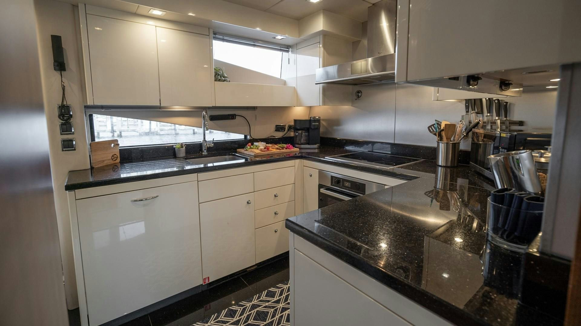 a kitchen with white cabinets aboard SPLASHED OUT Yacht for Sale