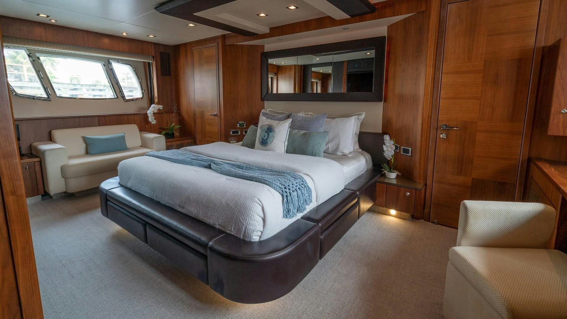 a room with a bed and a couch aboard SPLASHED OUT Yacht for Sale