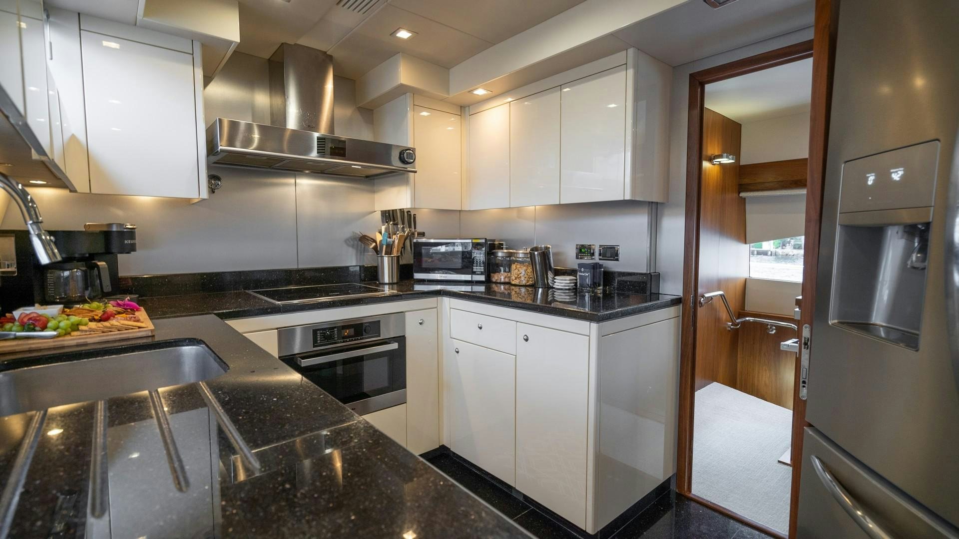 a kitchen with white cabinets aboard SPLASHED OUT Yacht for Sale