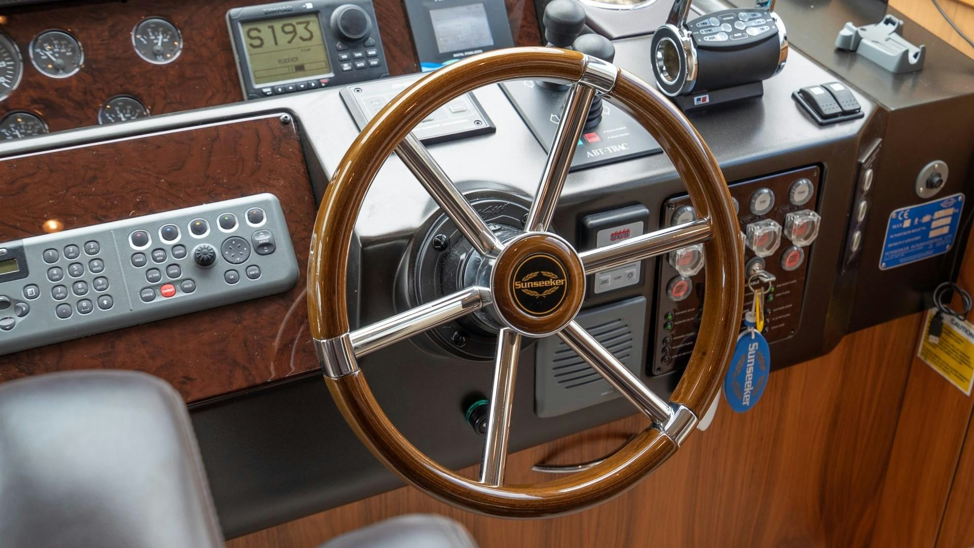 a steering wheel and control panel of a car aboard SPLASHED OUT Yacht for Sale