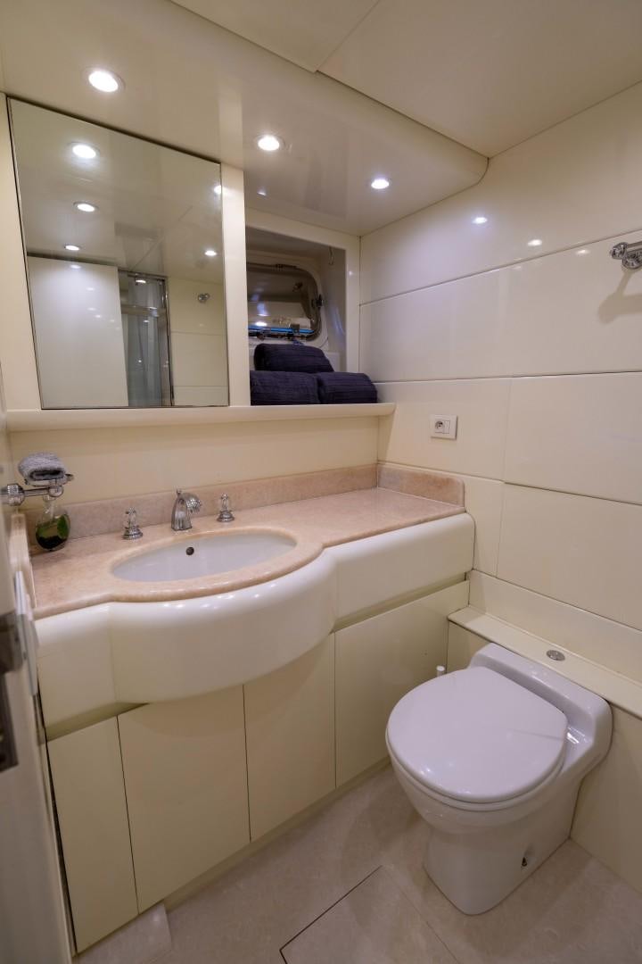 a bathroom with a toilet and a sink aboard THE PEARL Yacht for Sale