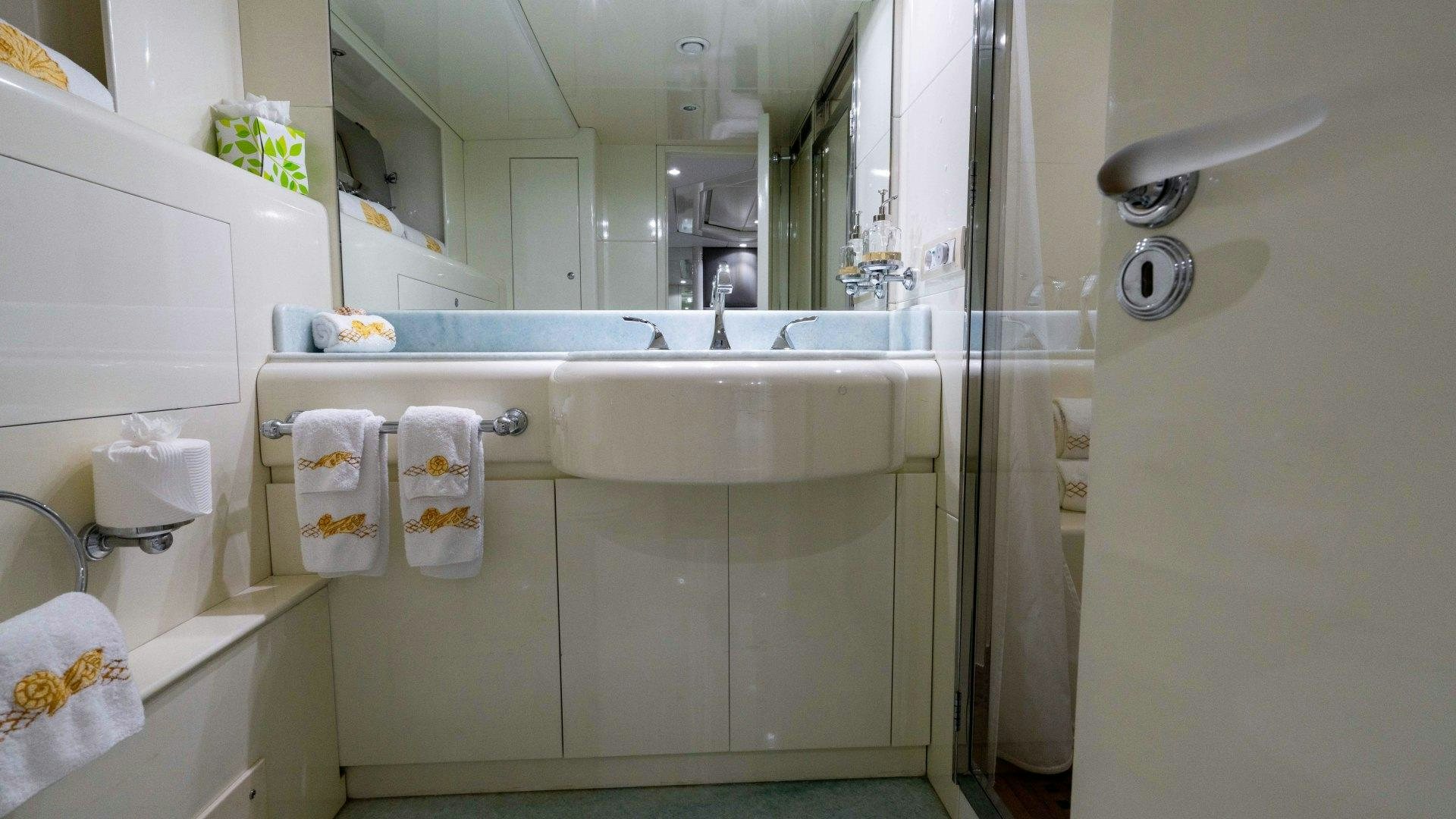 a bathroom with a large mirror aboard THE PEARL Yacht for Sale