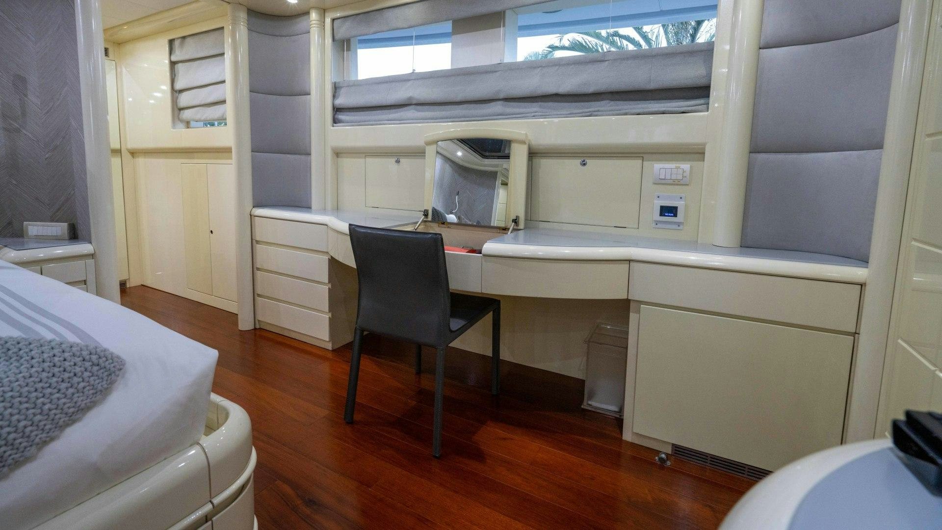 a room with a chair and a bed aboard THE PEARL Yacht for Sale