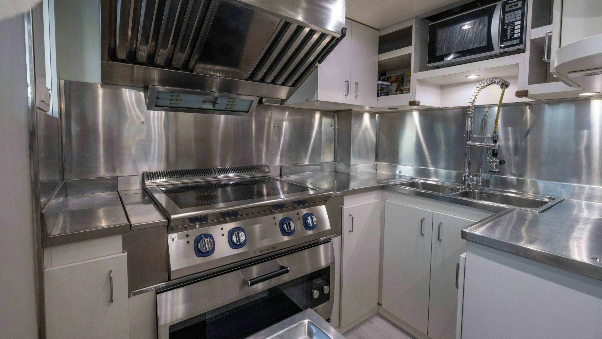 a kitchen with stainless steel appliances aboard THE PEARL Yacht for Sale