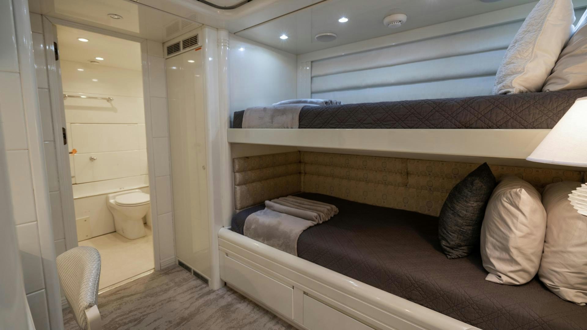 a room with a bed and a couch aboard THE PEARL Yacht for Sale