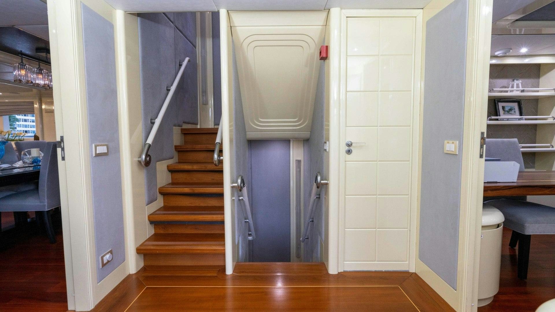 a hallway with a door and a chair aboard THE PEARL Yacht for Sale