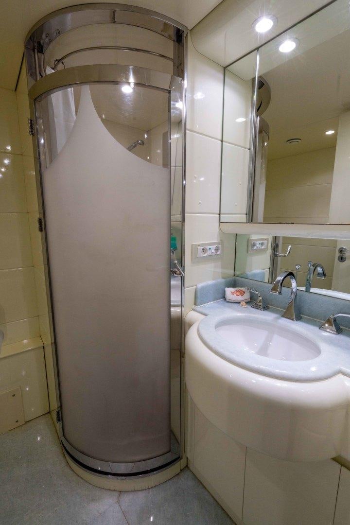 a bathroom with a urinal and sink aboard THE PEARL Yacht for Sale