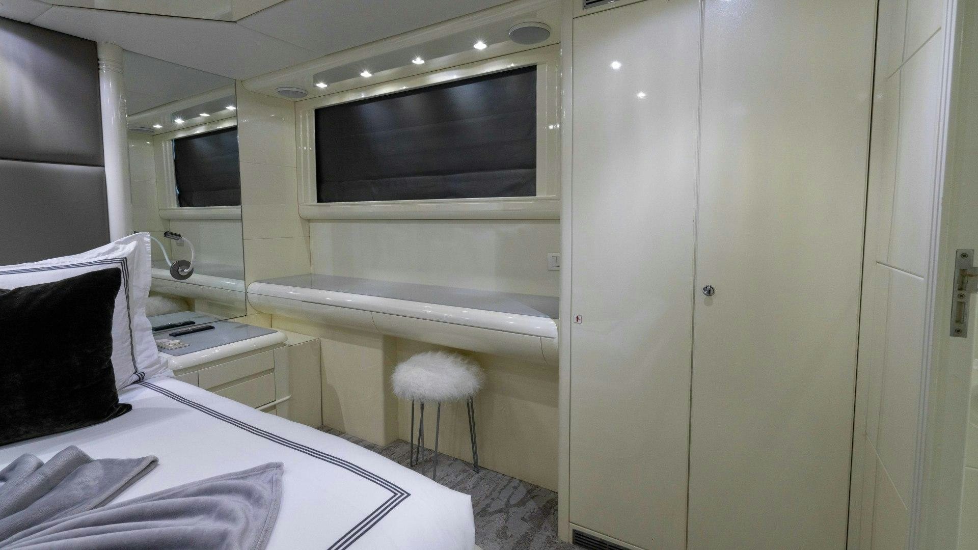 a room with a bed and a television aboard THE PEARL Yacht for Sale