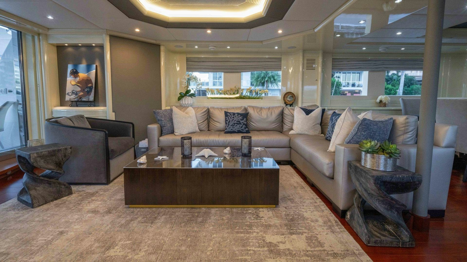 a living room with a couch and coffee table aboard THE PEARL Yacht for Sale