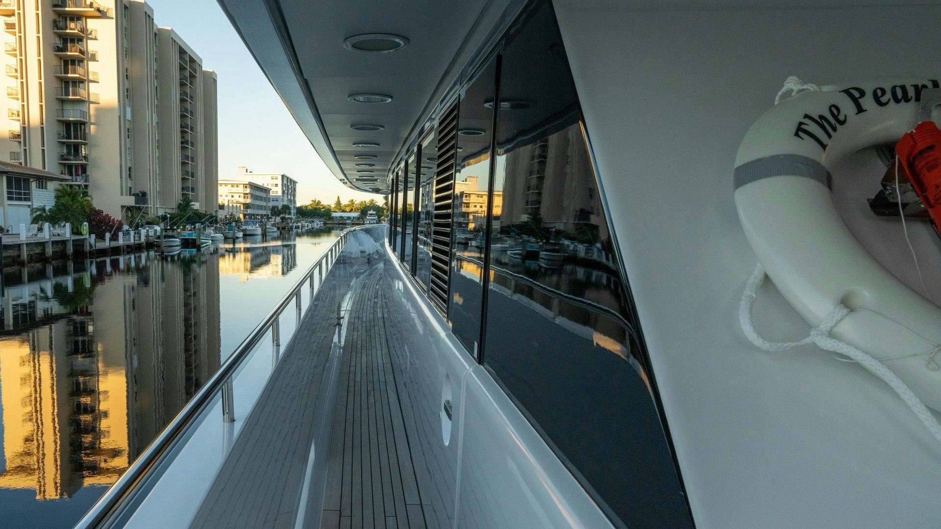 a walkway with a railing and a railing with a railing and a building with a railing and a aboard THE PEARL Yacht for Sale