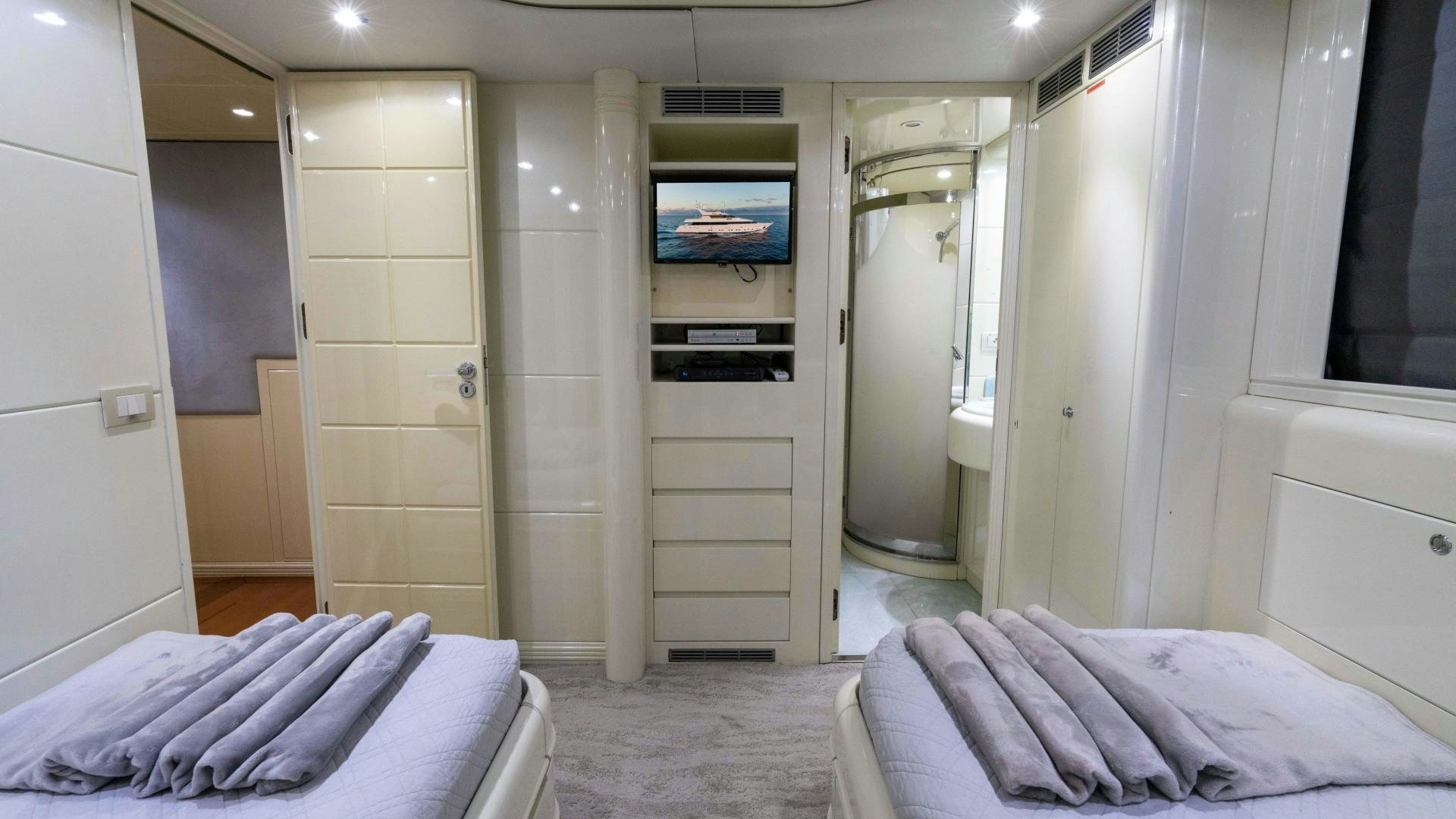 a room with a bed and a tv aboard THE PEARL Yacht for Sale