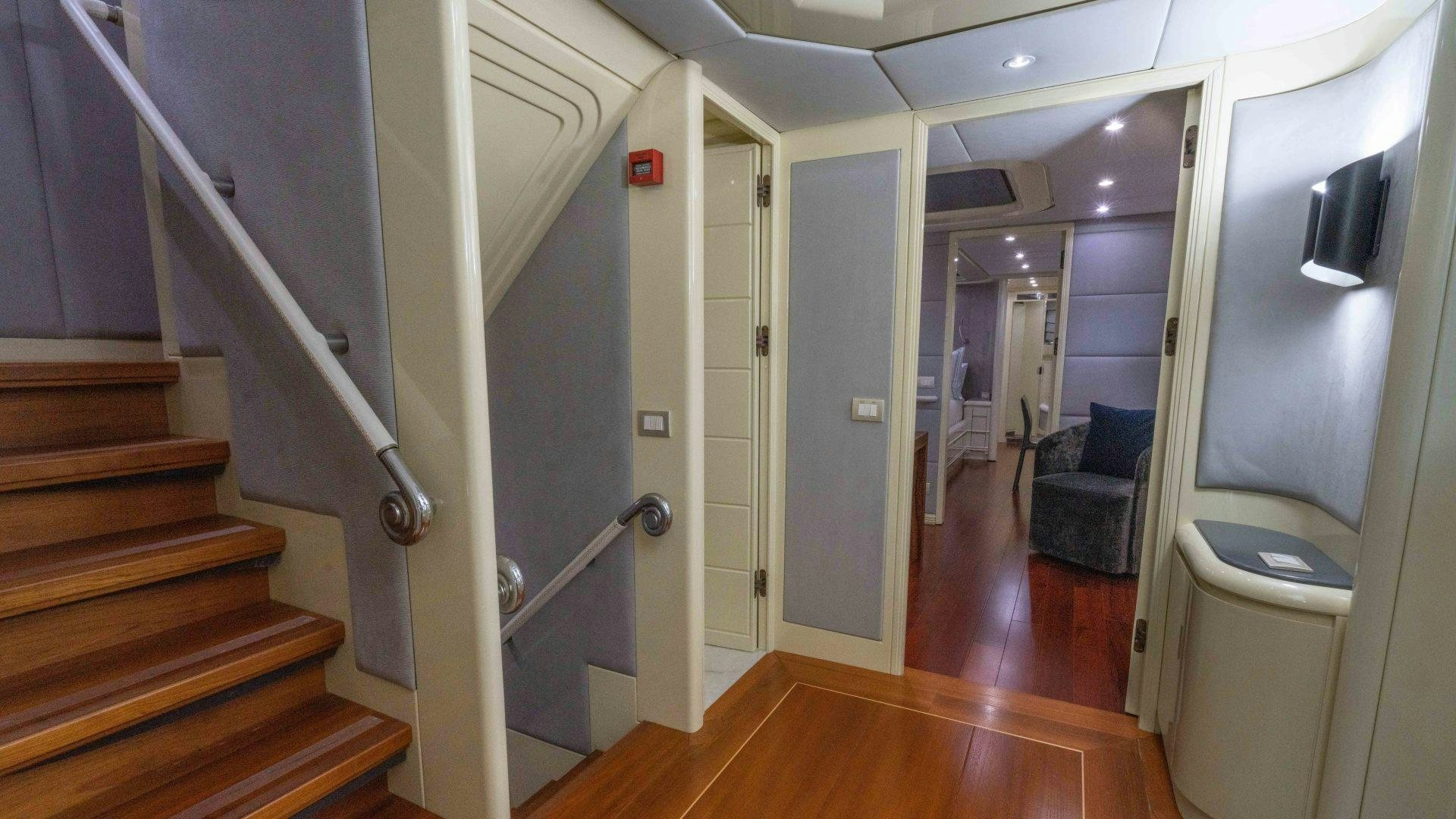 a hallway with a door and a couch aboard THE PEARL Yacht for Sale