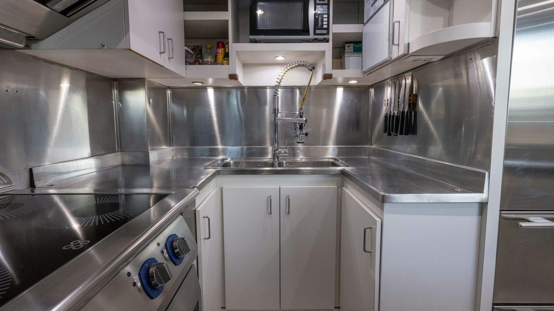 a kitchen with stainless steel appliances aboard THE PEARL Yacht for Sale