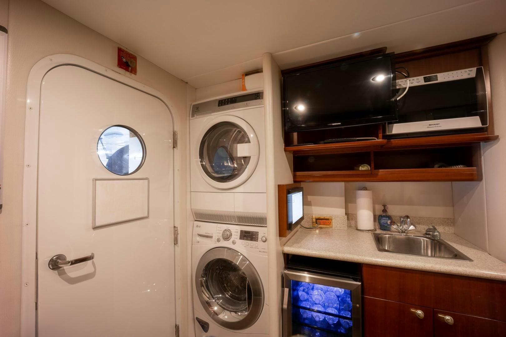 a washer and dryer in a room aboard PASSION Yacht for Sale