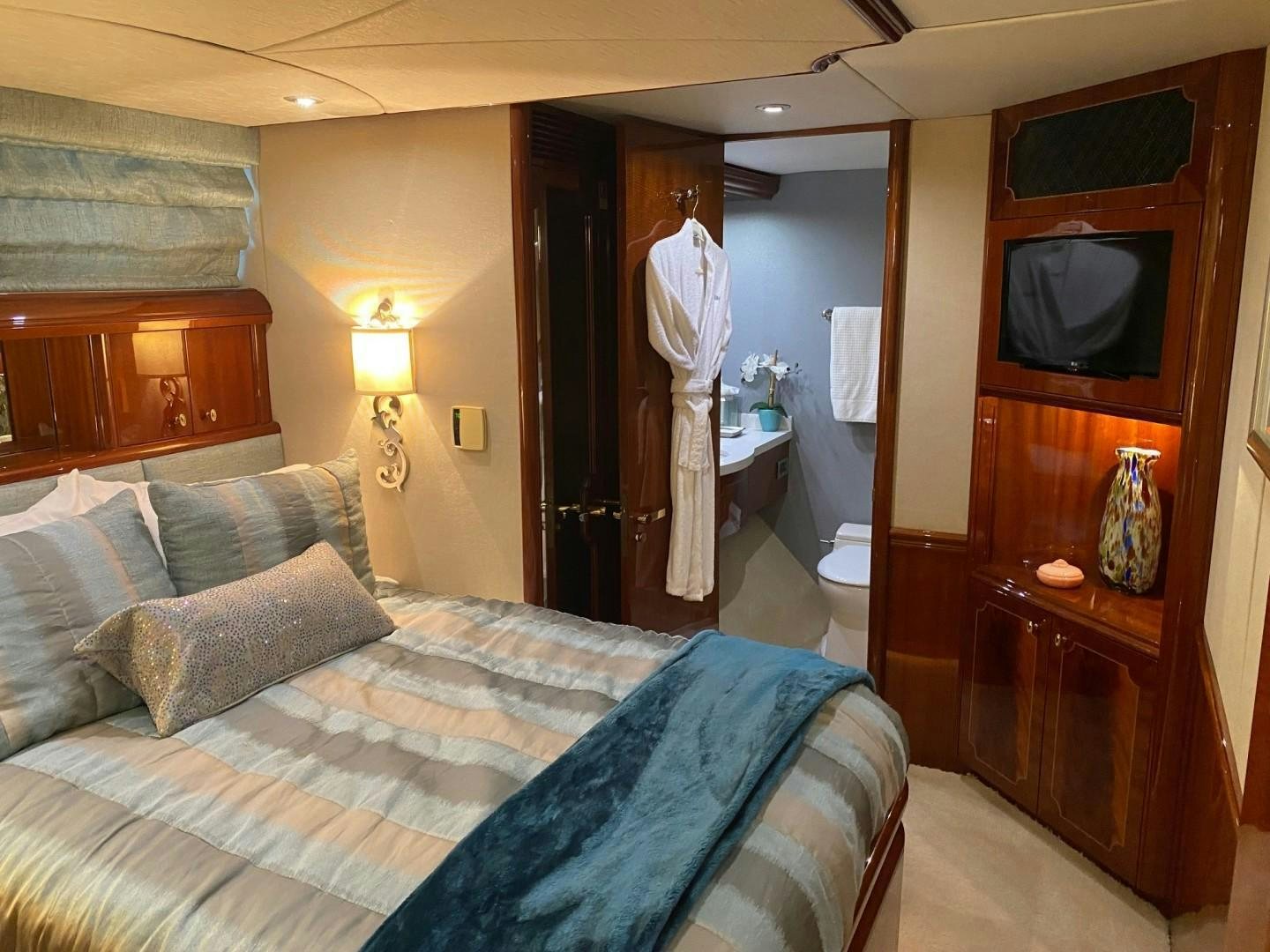 a bedroom with a bed and a television aboard PASSION Yacht for Sale