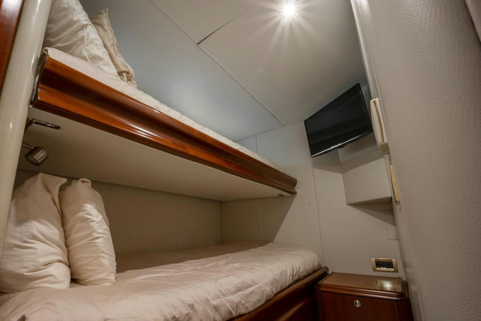 a bed with a television on top of it aboard PASSION Yacht for Sale