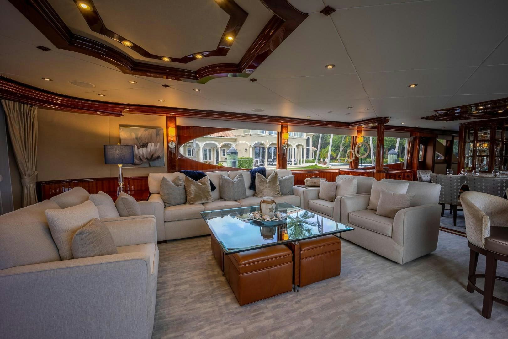 a living room with a large glass table and a large window aboard PASSION Yacht for Sale